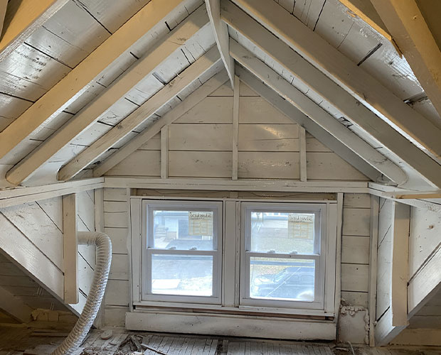 Attic roof sheathing showing mold growth caused by inadequate ventilation